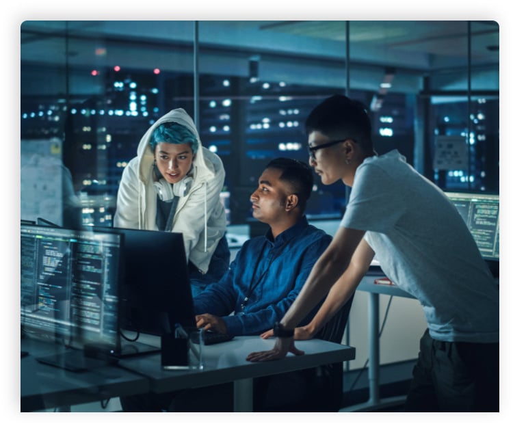 A group of people surround a computer screen