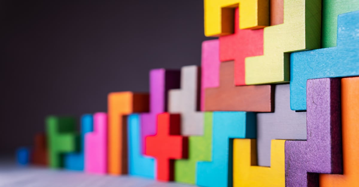 Colorful interlocking building block shapes stacked up at an angle